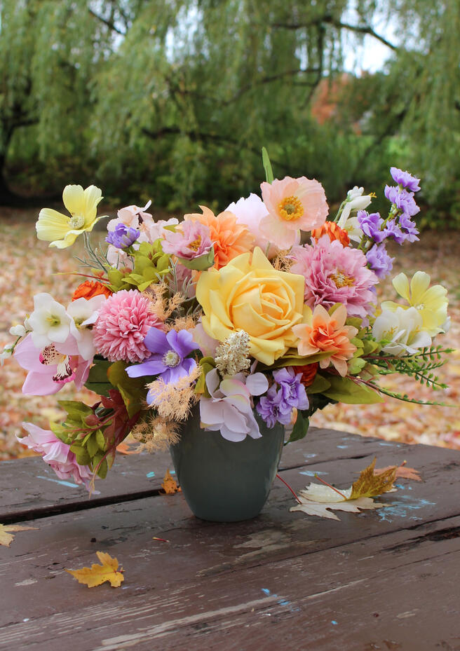Bright coloured silk bouquet with roses, ranunculus, anemone, hibiscus and wisteria.